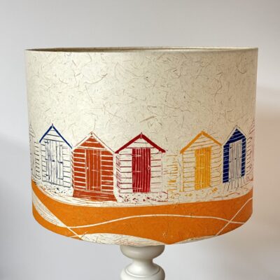 Brightly coloured handprinted beach huts drum lampshade