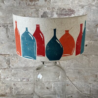 Mulitcoloured handprinted bottles table lamp by ArtShades