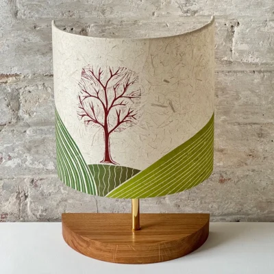 Lampshade with handprinted tree and hills in green and browns