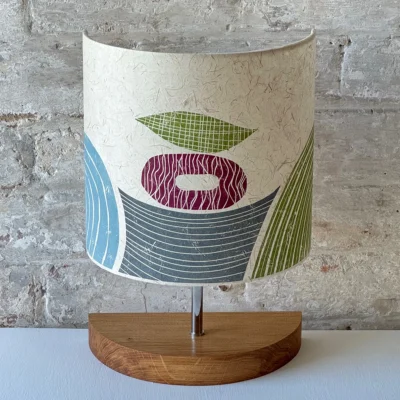Contemporary lampshade with lake, hills and floating shapes