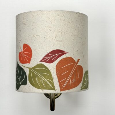 Wall light shade with leaves in oranges and greens on cream background by ArtShades