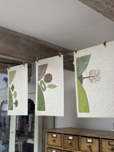 Handprinted linocuts pegged for drying